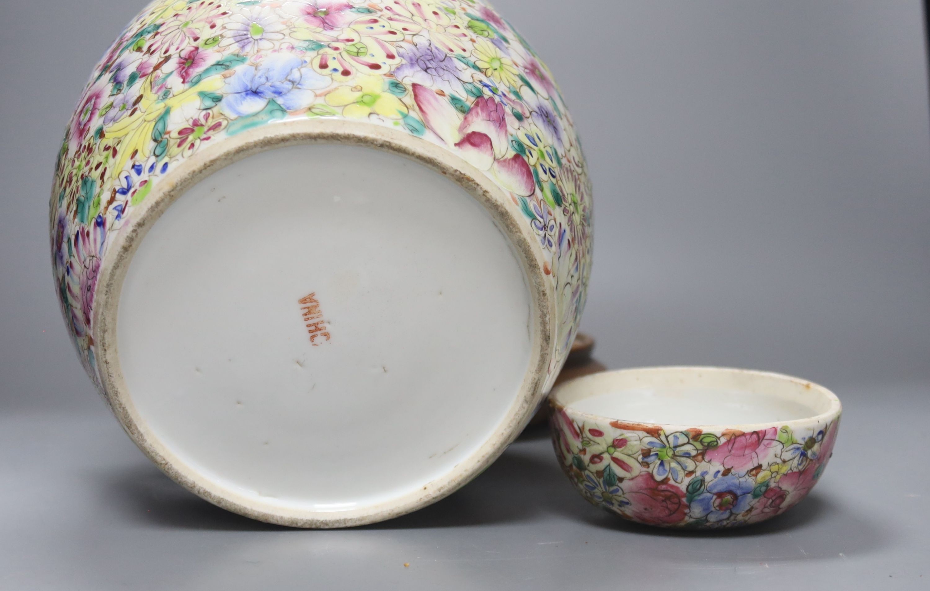 A Chinese thousand flower famille rose jar and cover, early 20th century, wood stand 28cm